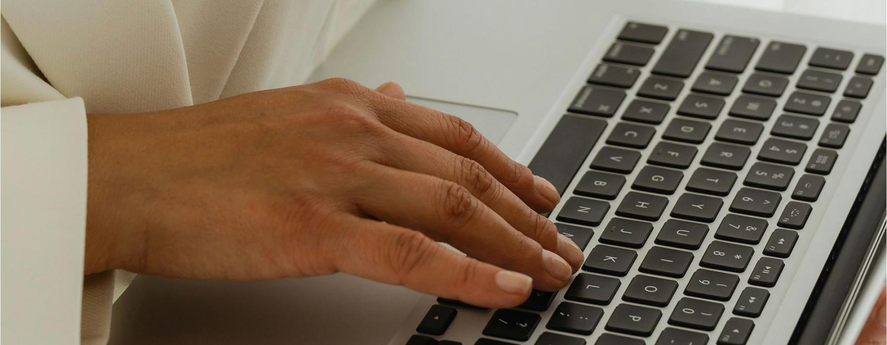 a person typing on a laptop